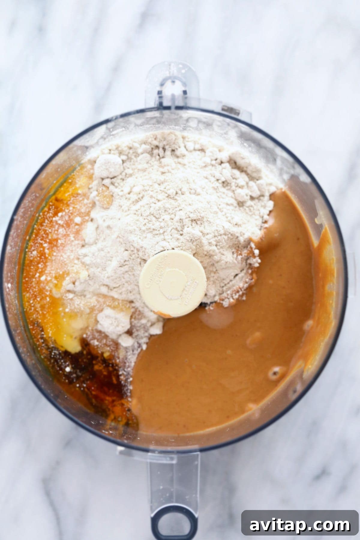 All ingredients loaded into a food processor, ready to be blended into homemade protein bar dough.