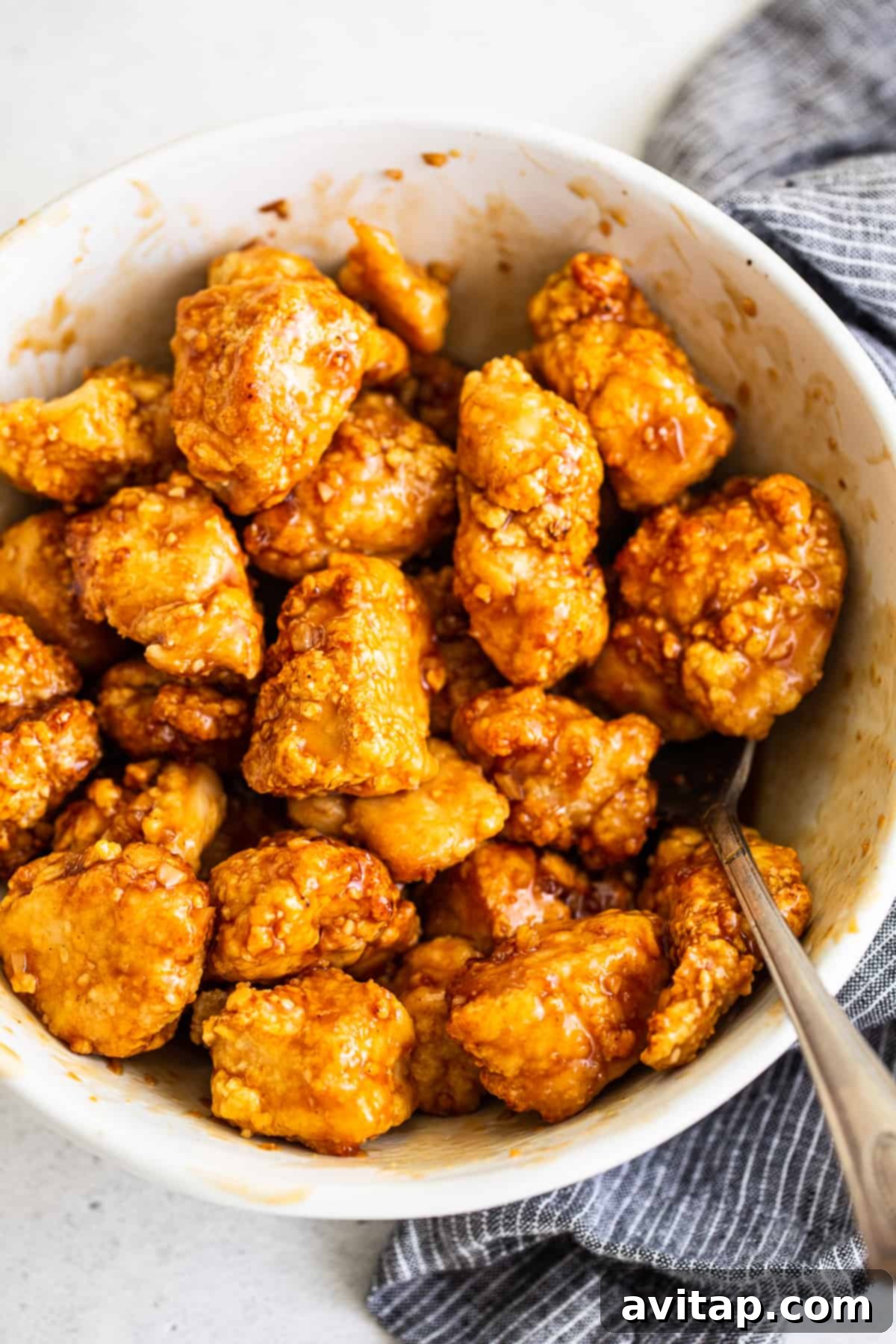 Crispy air fryer chicken tossed in a glossy honey sesame sauce, ready to serve.