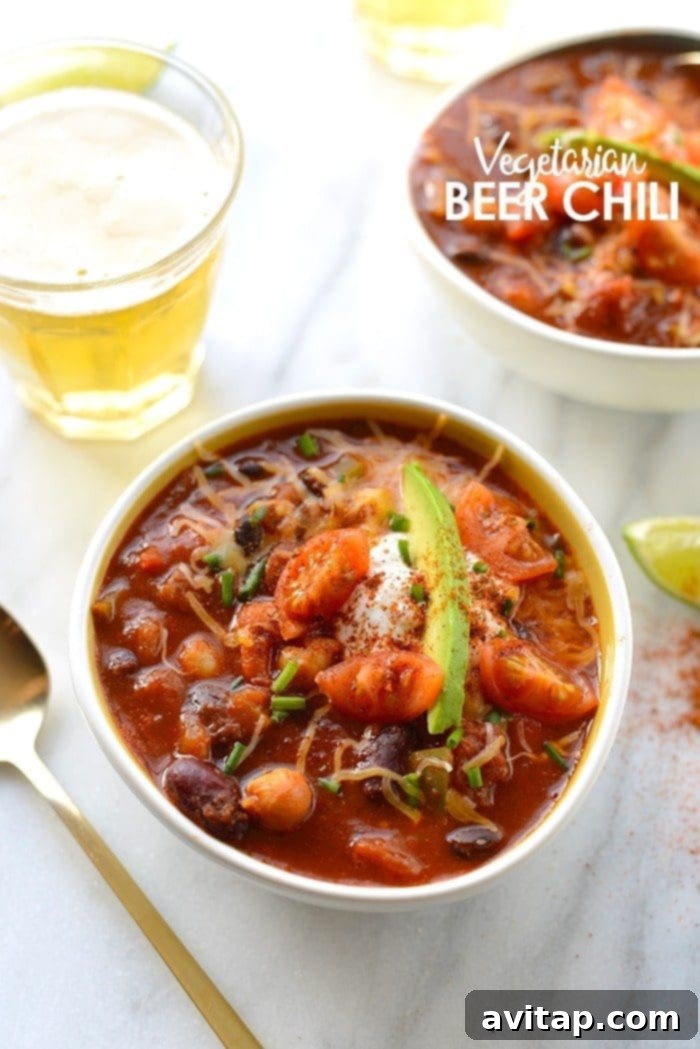 Hearty bowl of vegetarian beer chili topped with fresh herbs and a swirl of cream.