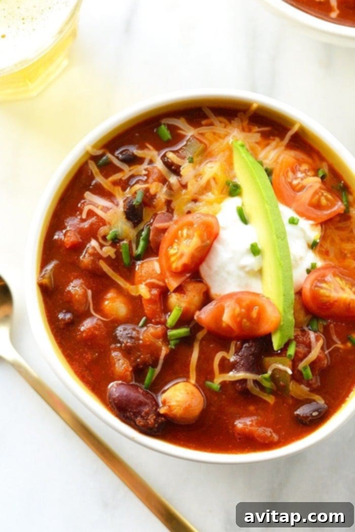 Overhead shot of a large pot filled with steaming vegetarian beer chili, ready to be served.