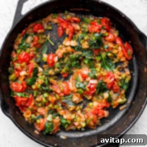 Sautéd vegetables in a skillet pan, cooked until softened and most liquid has evaporated.
