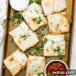 A perfectly sliced sheet pan quesadilla, cut into neat squares, ready for serving with various toppings.