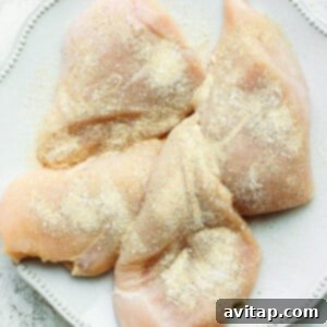 Chicken breast seasoned with garlic powder, salt, and pepper.