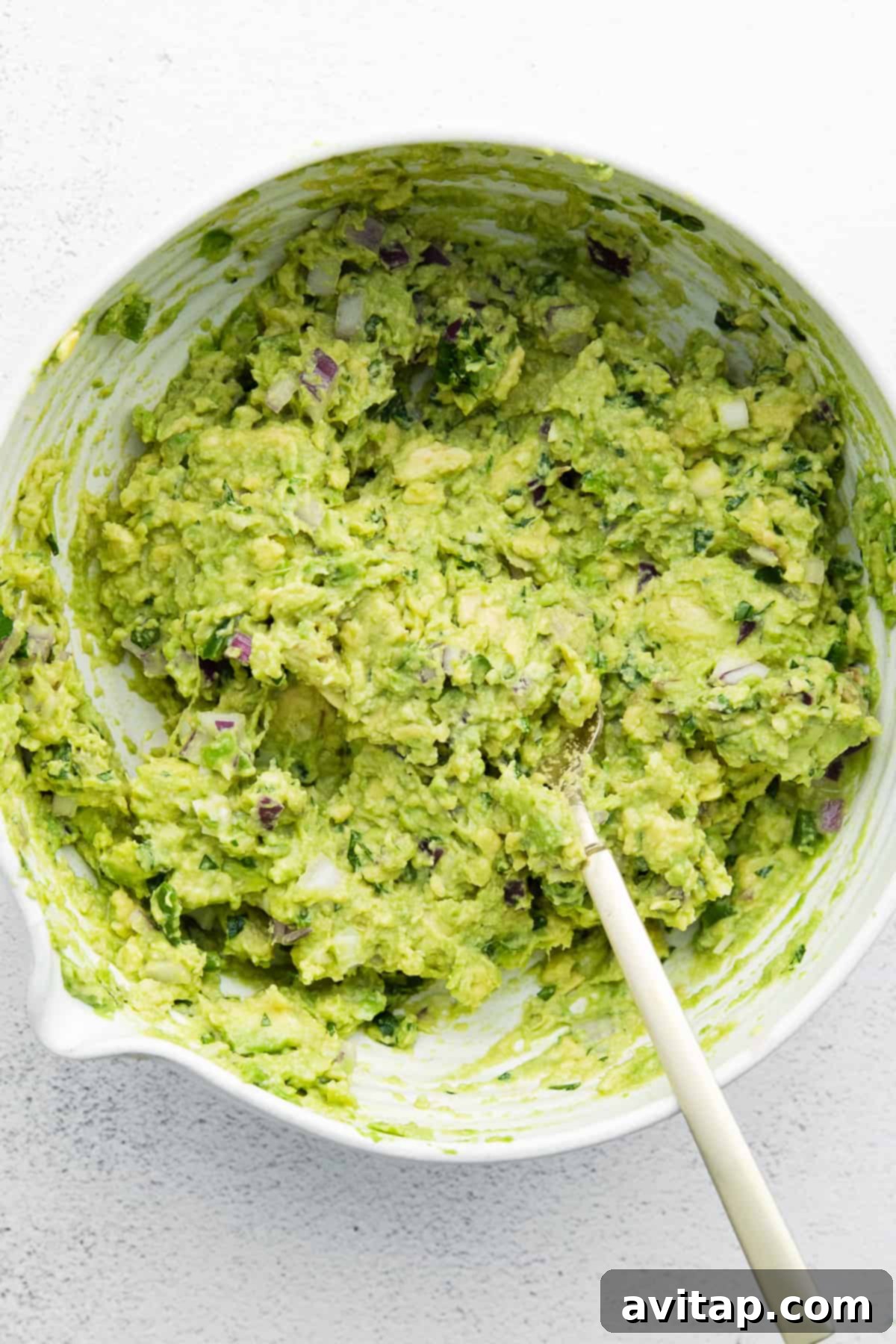 A bowl of fresh guacamole garnished with cilantro, illustrating perfect presentation.