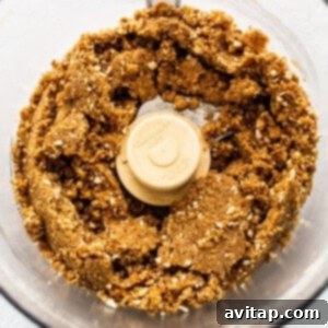 Crushed pretzels mixed with butter and agave in a food processor, forming the crust base.