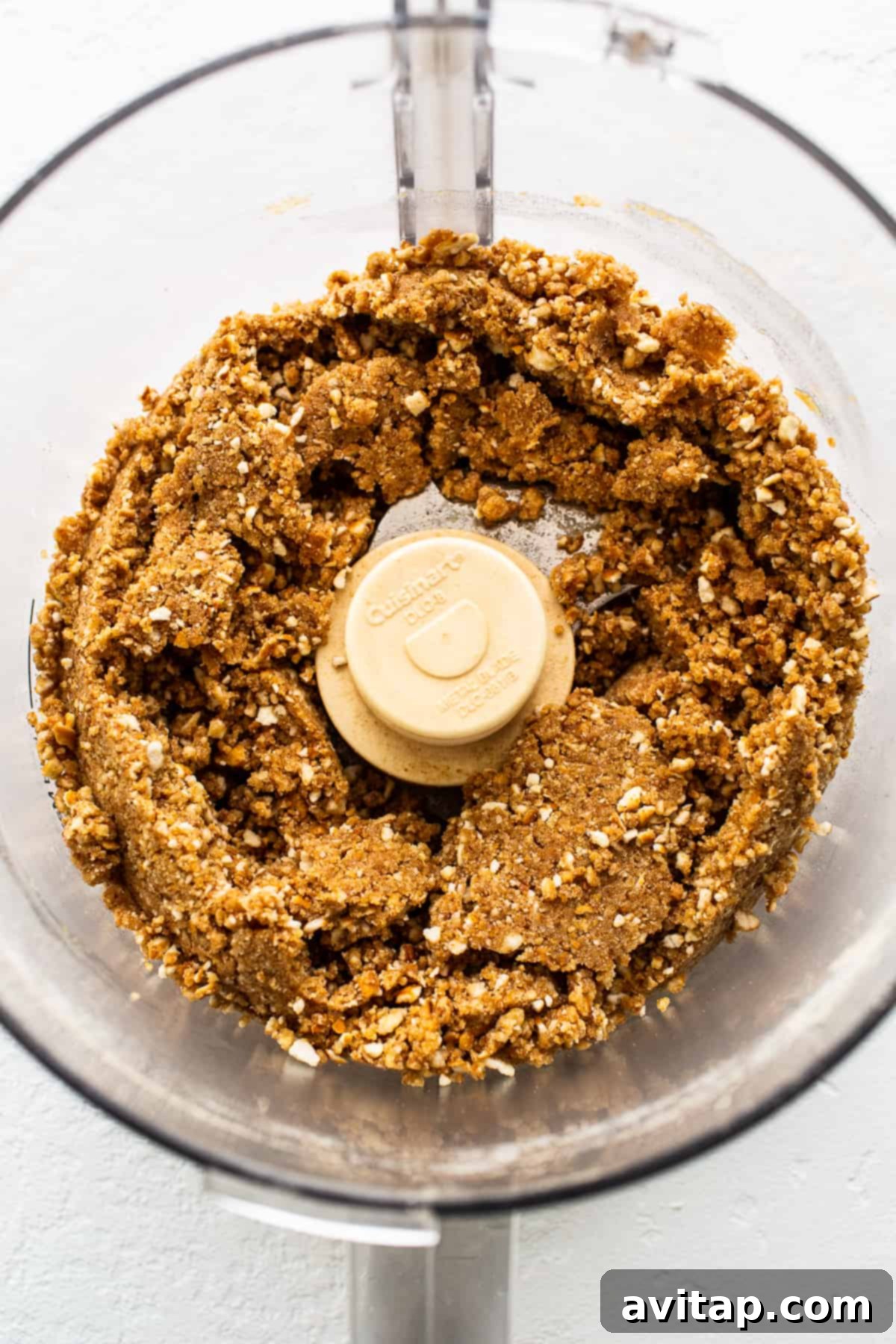 Crushed pretzels being prepared in a mixer for the pie crust, highlighting the initial step of the recipe.