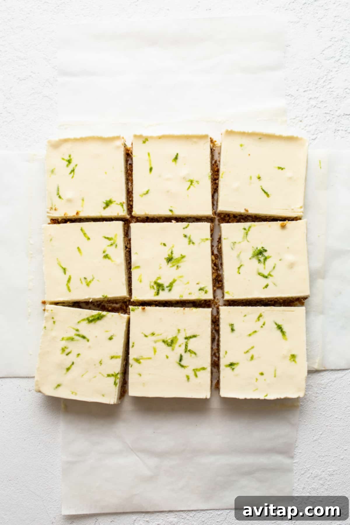 Perfectly sliced margarita pie bars arranged on parchment paper, ready to be served.