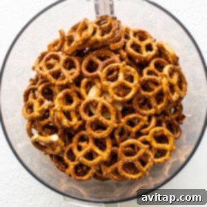 Pretzels being crushed in a food processor for the crust.
