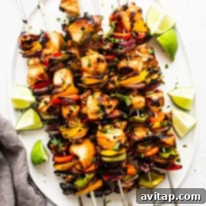 Finished chicken kabobs artfully arranged on a serving plate.