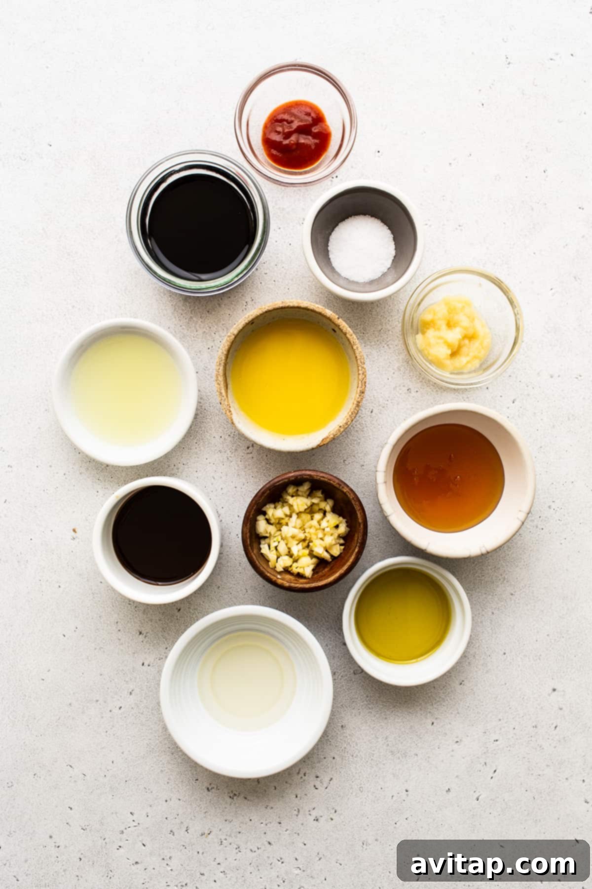 A vibrant selection of grilled chicken kabob ingredients laid out in small bowls.