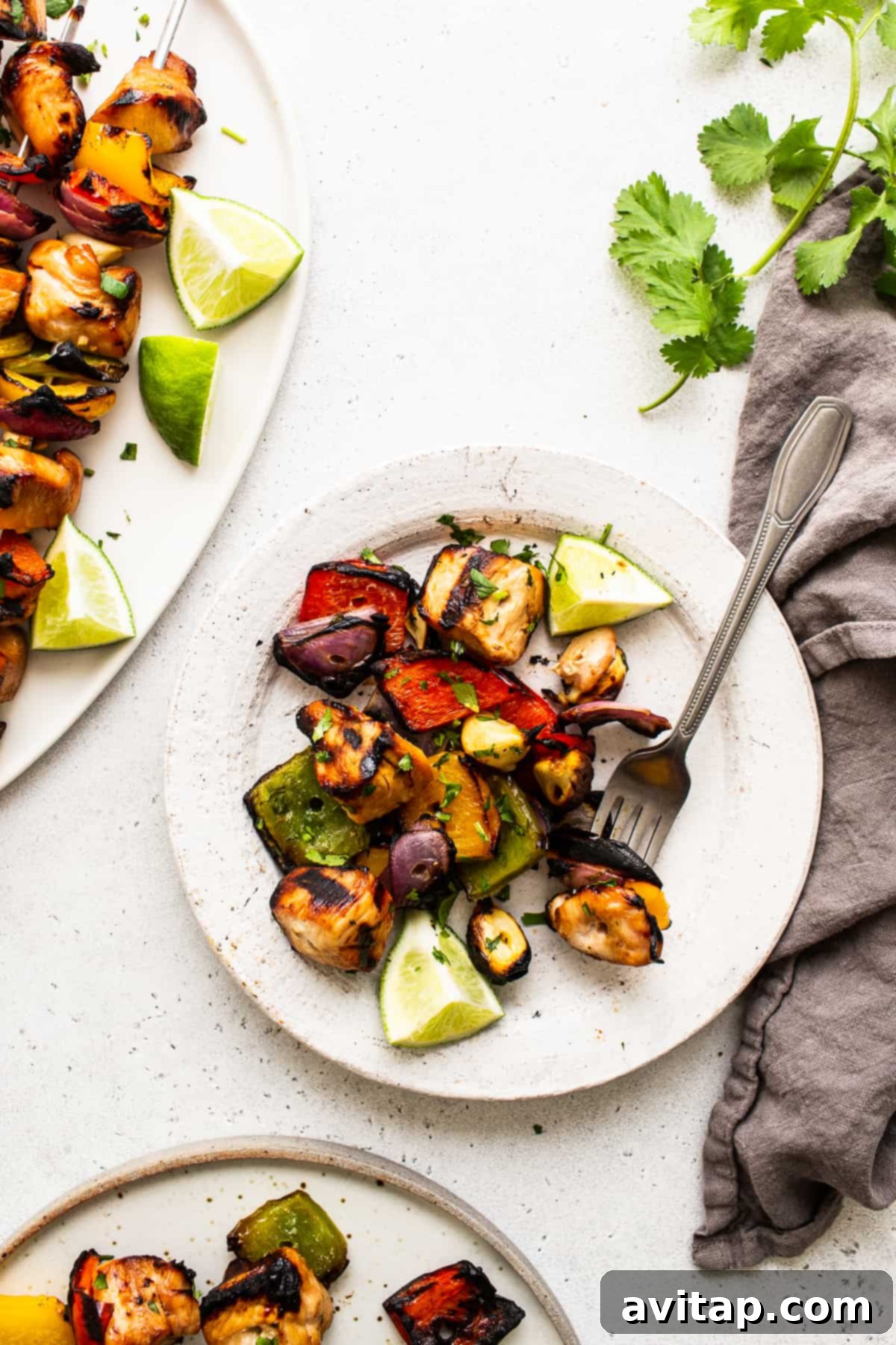 A plate featuring perfectly grilled chicken and vibrant vegetables, ready to be enjoyed.