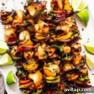 Delicious chicken kabobs expertly cooked and presented on a plate.