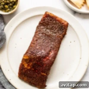 A perfectly smoked salmon fillet resting on a plate after cooking, allowing juices to redistribute.