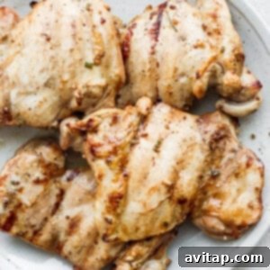 Flavorful Chicken Thighs Made Easy 3 Grilled boneless chicken thighs on a plate.