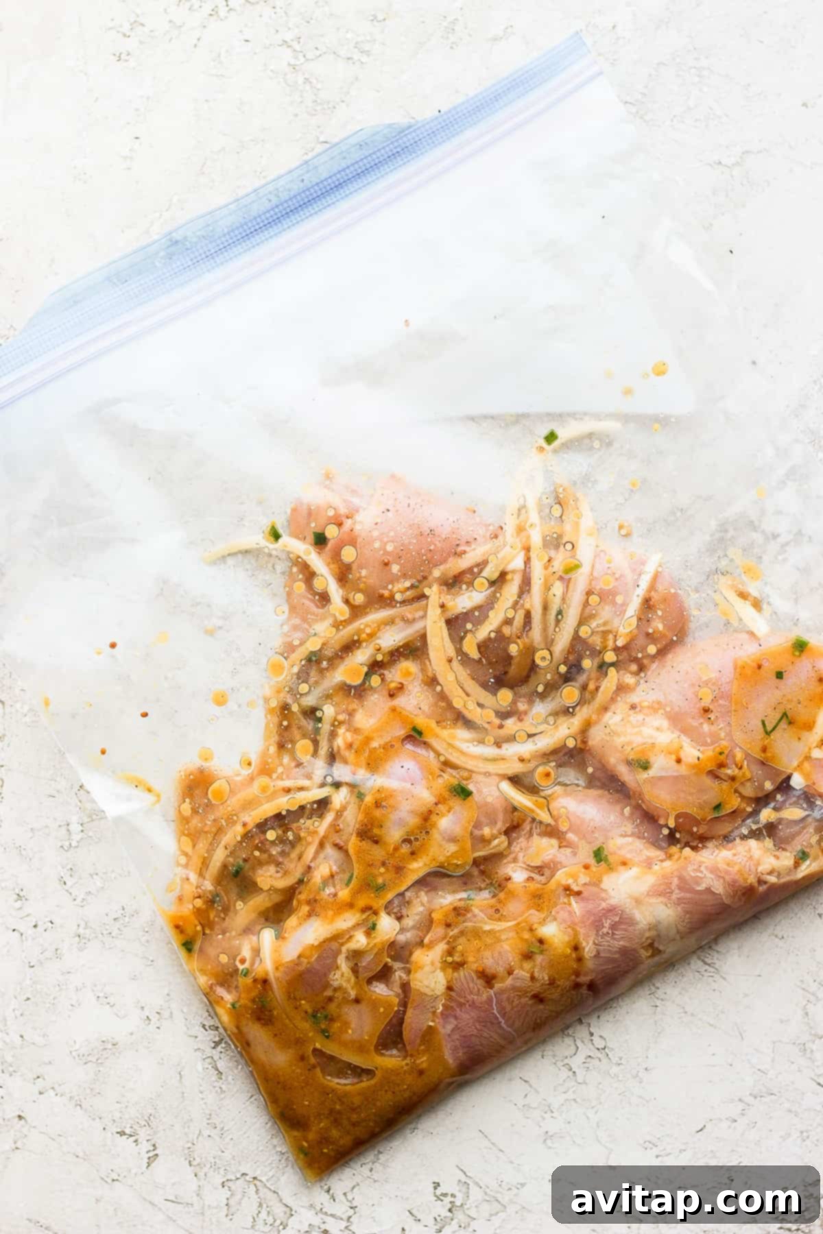 In less than 5 minutes you can whip up a delicious honey mustard chicken thighs marinade that will infuse your chicken thighs with mustard, honey and a hint of lemon! Marinated chicken thighs ready for cooking, sealed in a freezer bag.