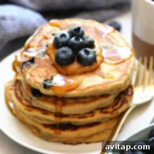 A vibrant, delicious stack of homemade blueberry protein pancakes, rich with whole grains and fresh berries, perfect for a healthy and energizing breakfast.