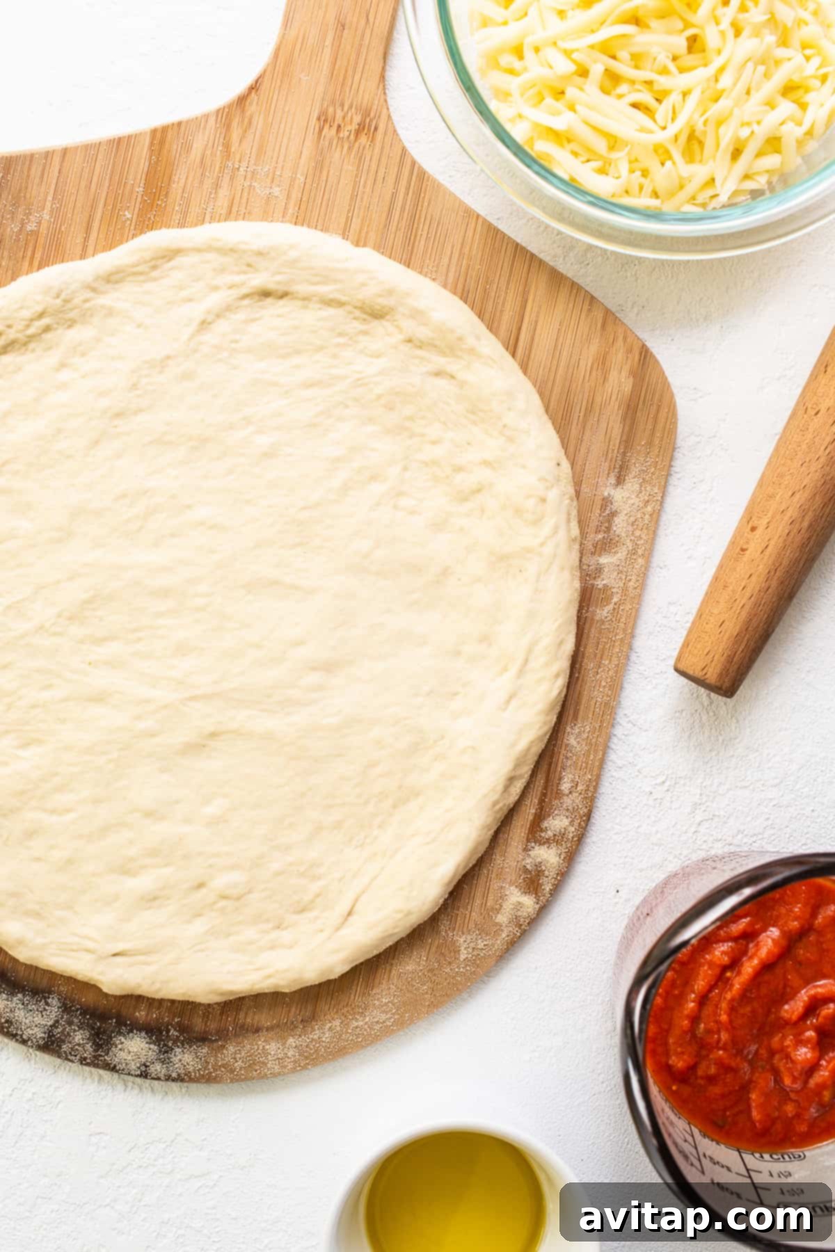 Closeup of a golden-brown pizza crust on a wooden cutting board, showcasing its perfect texture.
