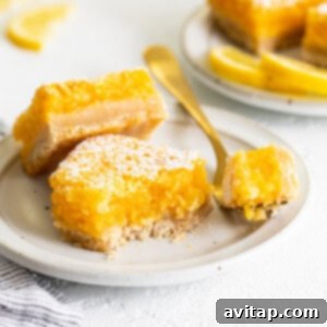 Classic lemon bars on a plate, ready to be enjoyed.