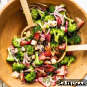 A beautifully presented bowl of fresh strawberry broccoli salad, ready to be served.