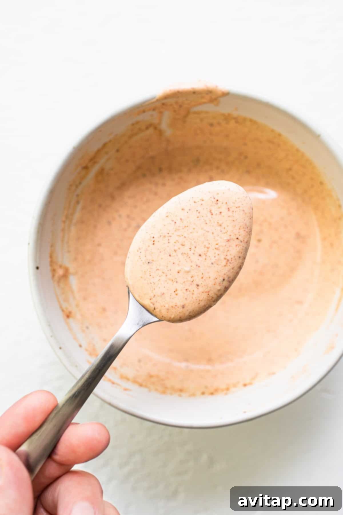 Burger sauce on a spoon.
