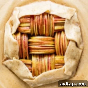 Assembled apple galette on a cutting board, ready for baking.