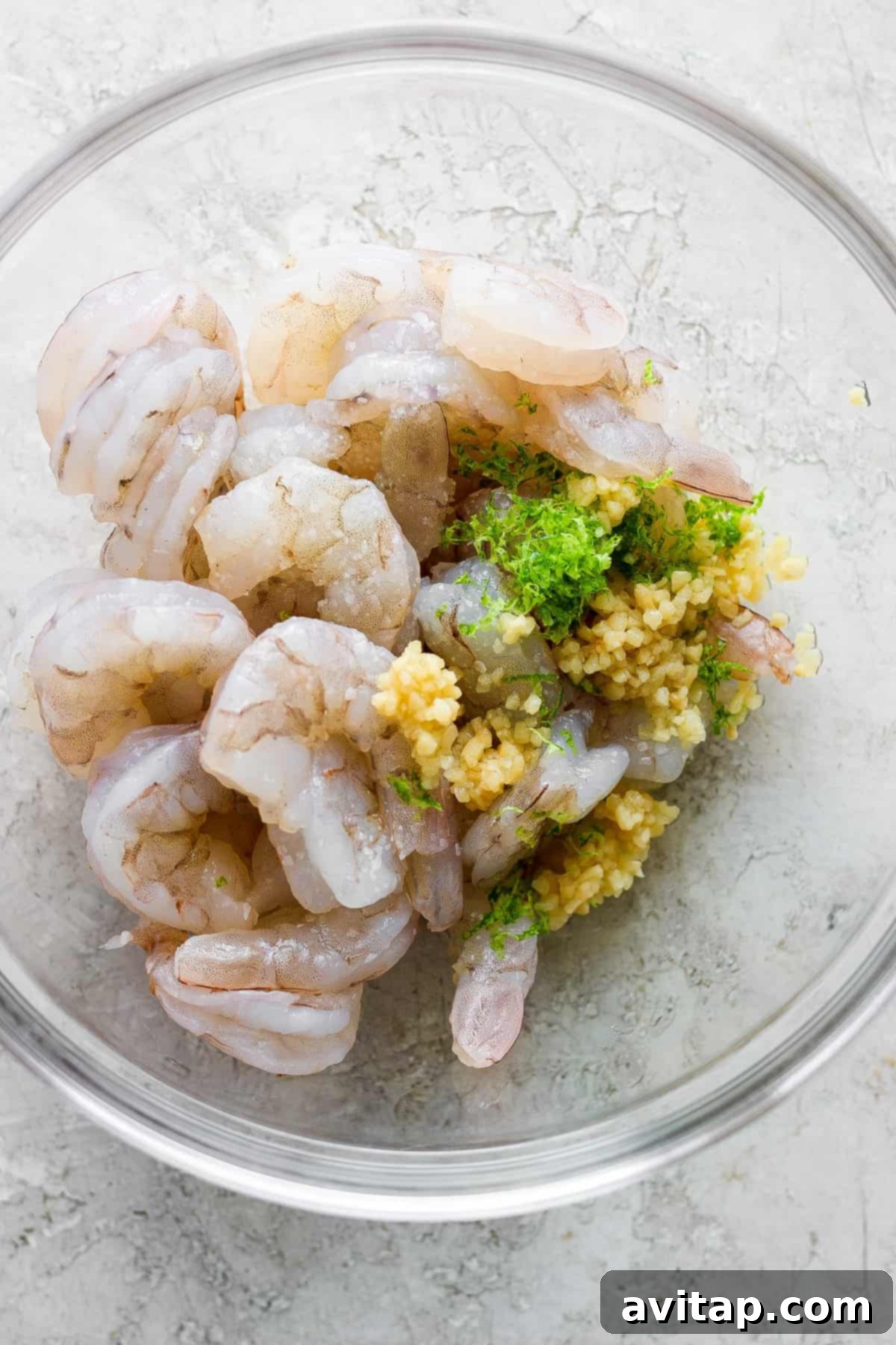 Close-up of perfectly cooked prawns seasoned with fresh cilantro and a light sprinkle of paprika, beautifully arranged and ready to be added to the bowl.