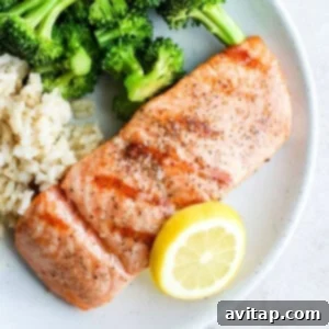 Grilled salmon on a plate, perfectly cooked with a flaky texture.