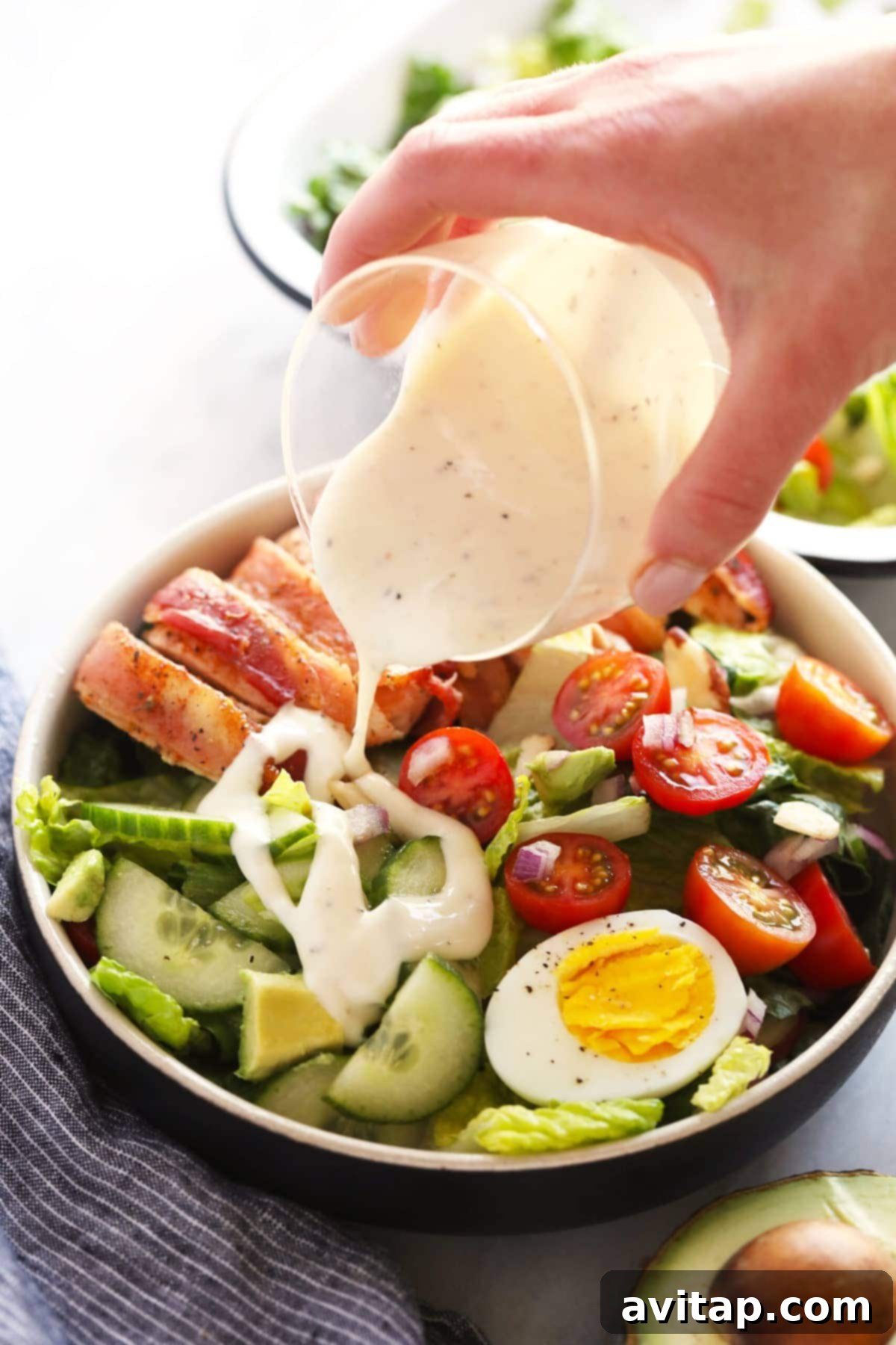 pouring dressing onto salad