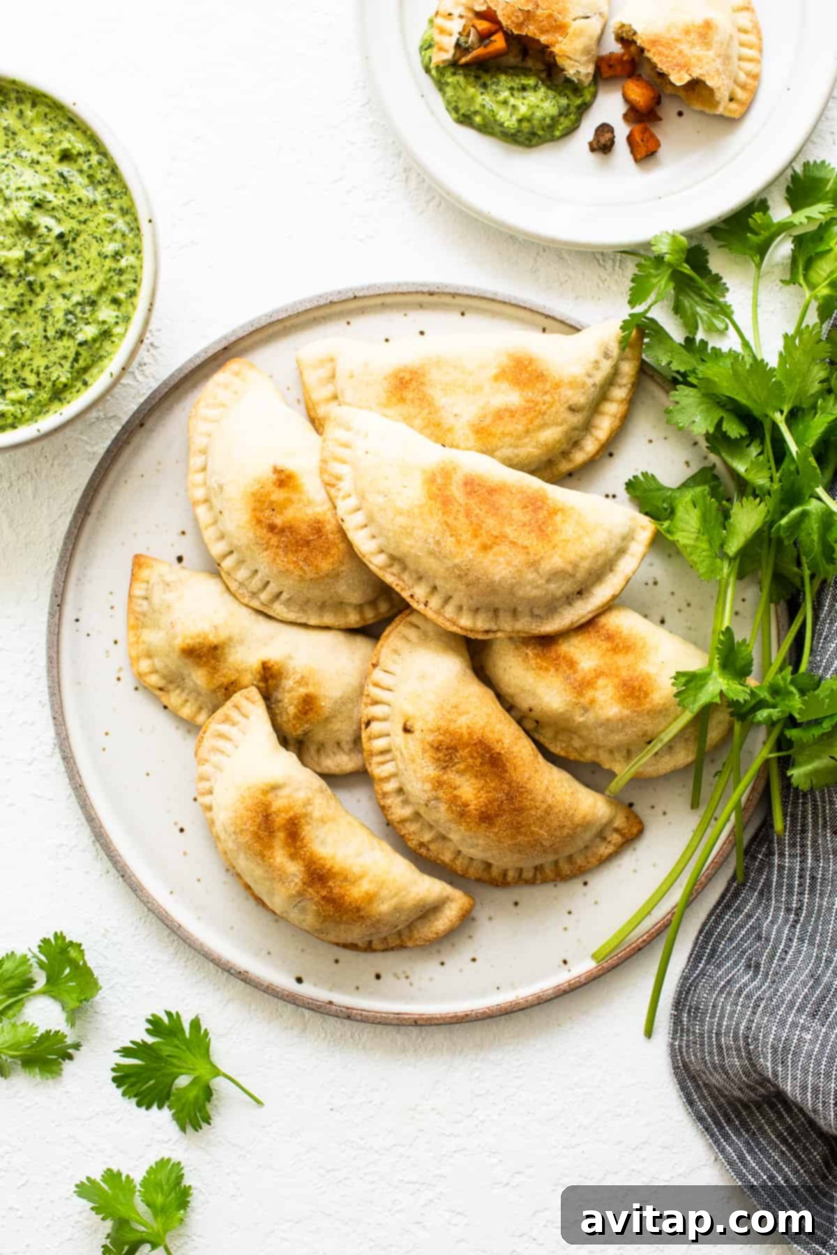 A close-up of a perfectly baked sweet potato ground beef empanada, showcasing its golden crust and delicious filling.