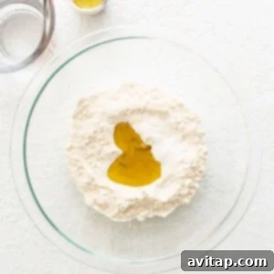 A bowl of flour, salt, and oil for empanada dough.