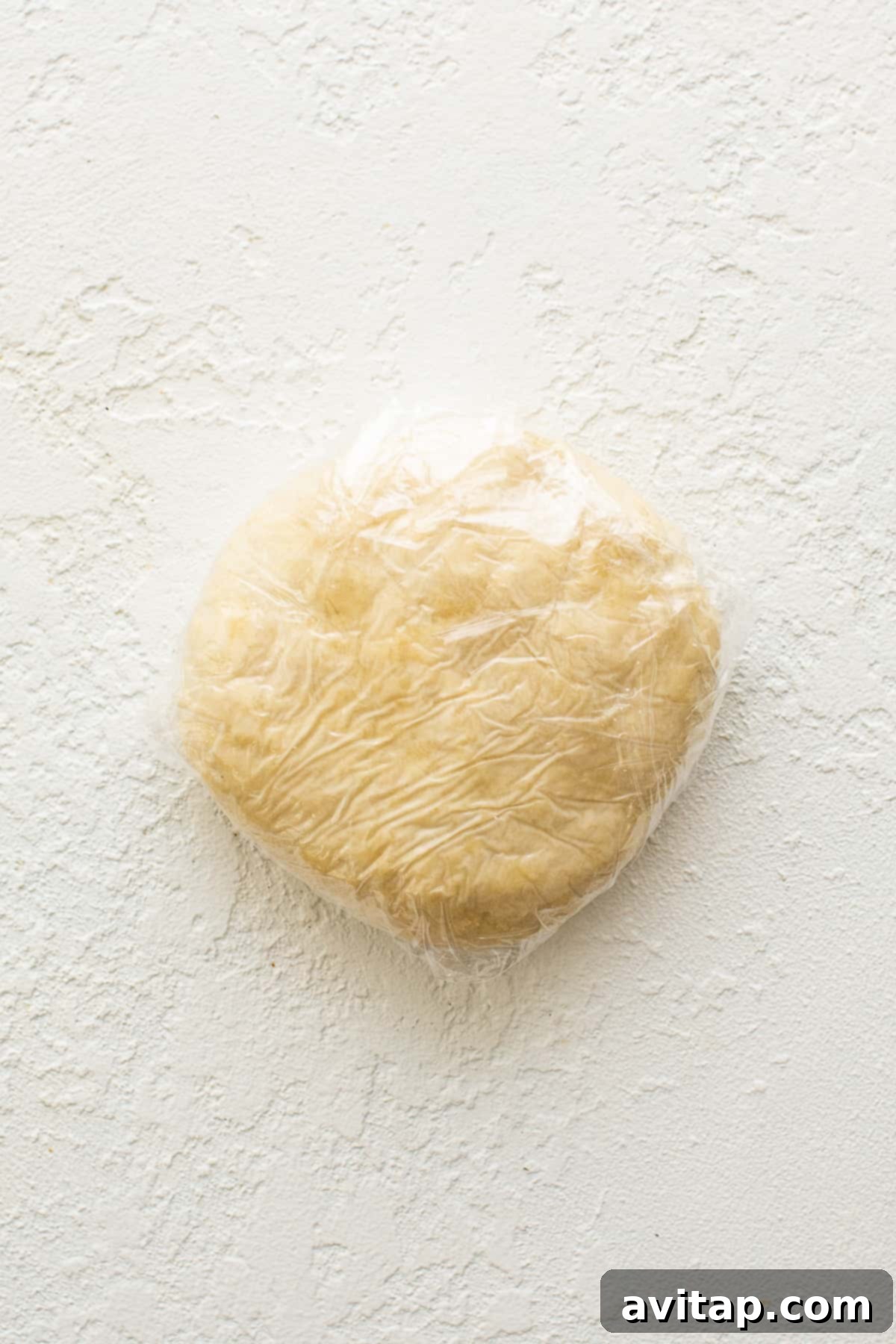 Freshly made empanada dough, perfectly wrapped in plastic, awaits its transformation into delicious pastries.