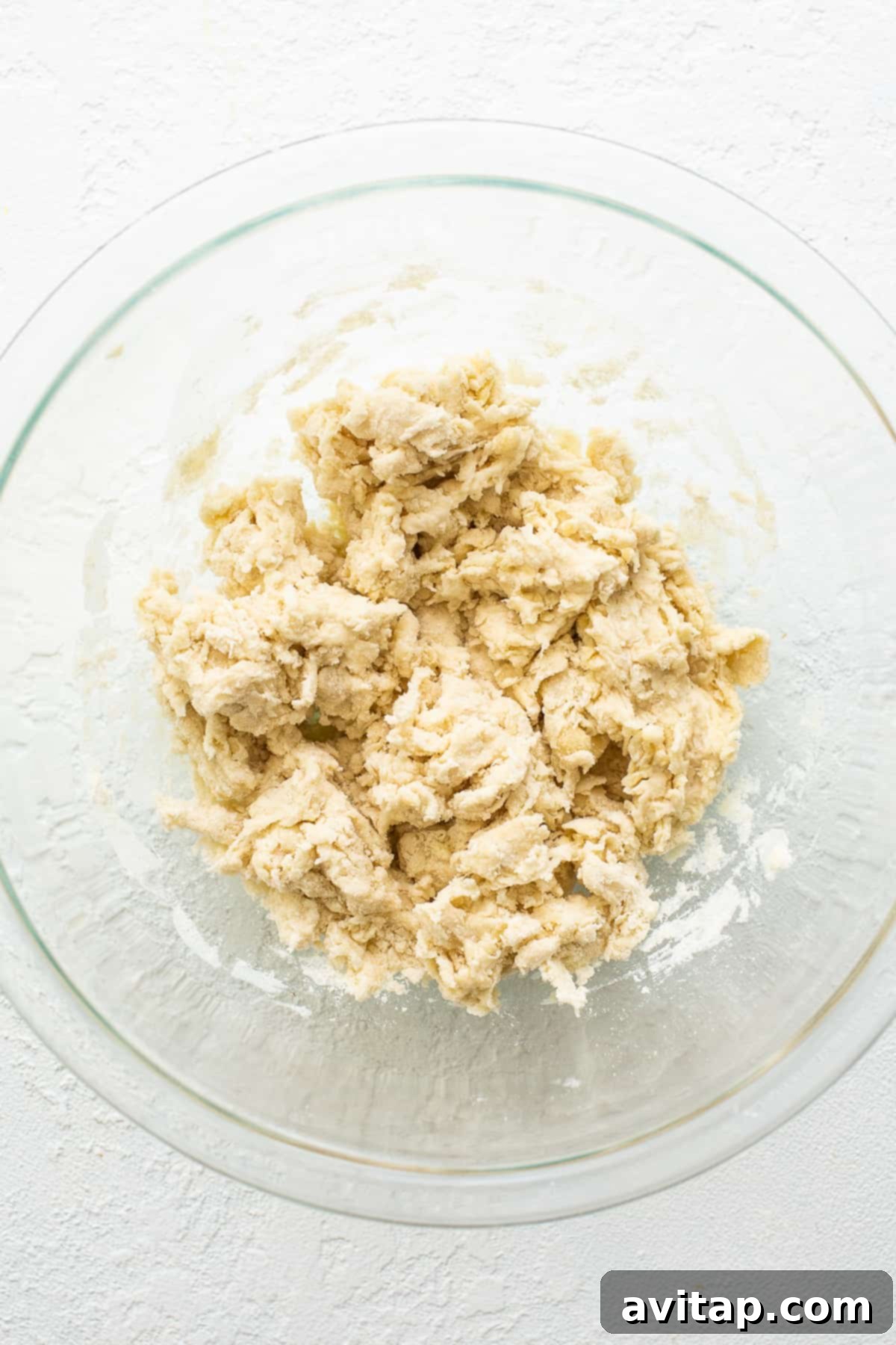 A bowl of rustic empanada dough, ready for chilling and rolling.