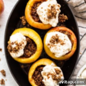 Stuffed apples in a skillet with whipped cream and granola, a complete dessert image.