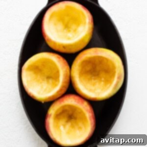 Sliced apples in a skillet, partially baked and ready for filling.