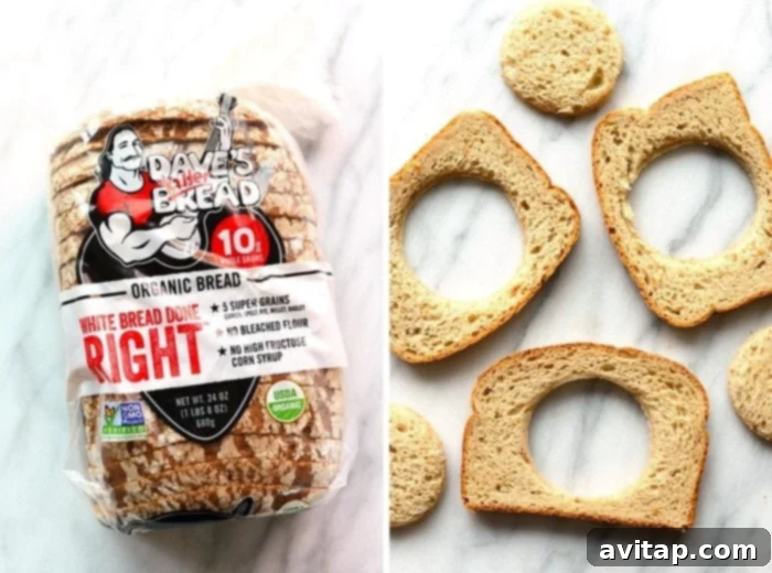 White bread slices with centers cut out from a cookie cutter, ready for Eggs in a Basket preparation.