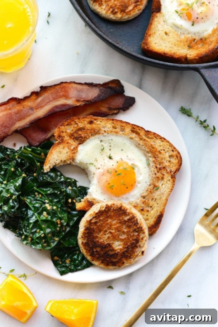 Eggs in a basket with a bite taken out, resting on a plate with fresh garnishes.
