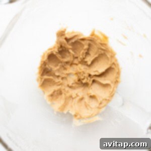 Creamed butter and sugar in a bowl, showing a light and fluffy texture after mixing, ready for the next steps.