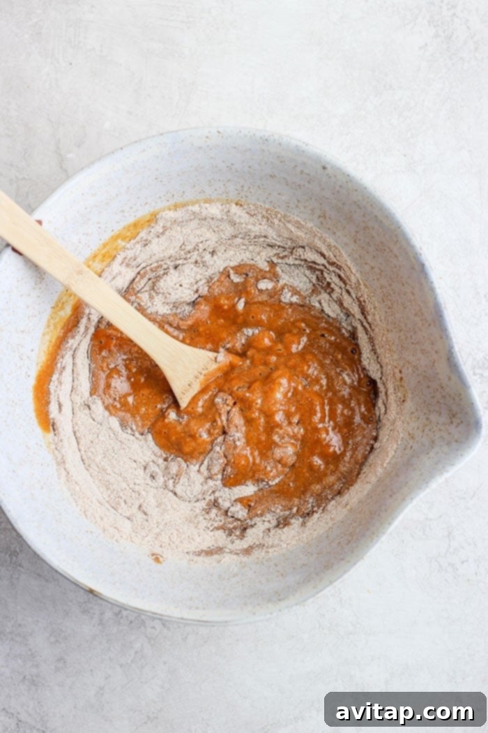 A collection of fresh, wholesome ingredients, including pumpkin puree, spices, and flour, laid out for healthy pumpkin bread preparation.