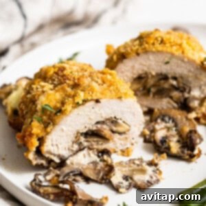 Gourmet Stuffed Pork Chops 5 A golden-brown stuffed pork chop on a white plate, ready to be served.