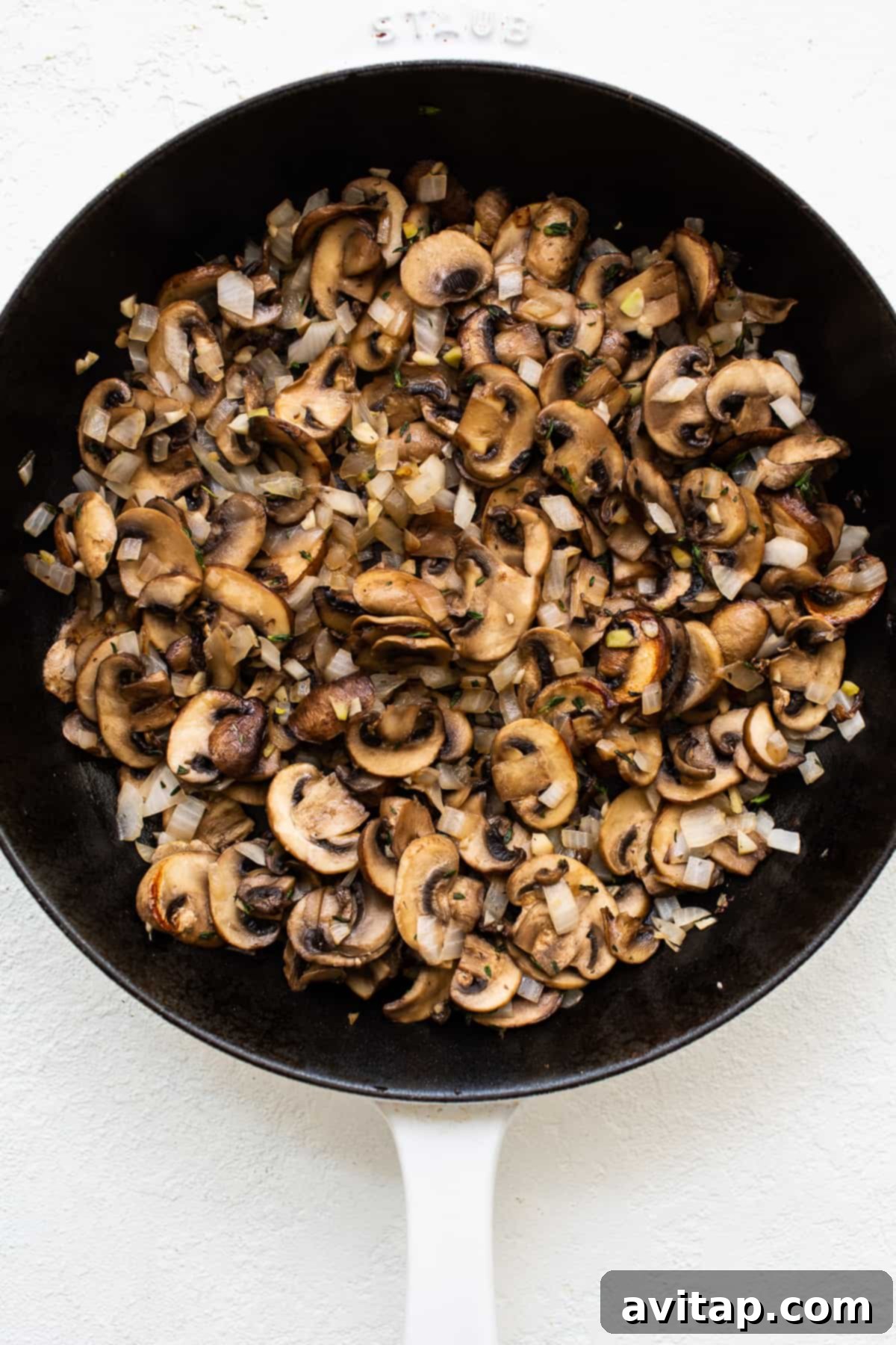 Caramelized Mushrooms: The Heart of the Stuffed Pork Chop Filling Skillet filled with richly caramelized mushrooms, ready for the stuffing.