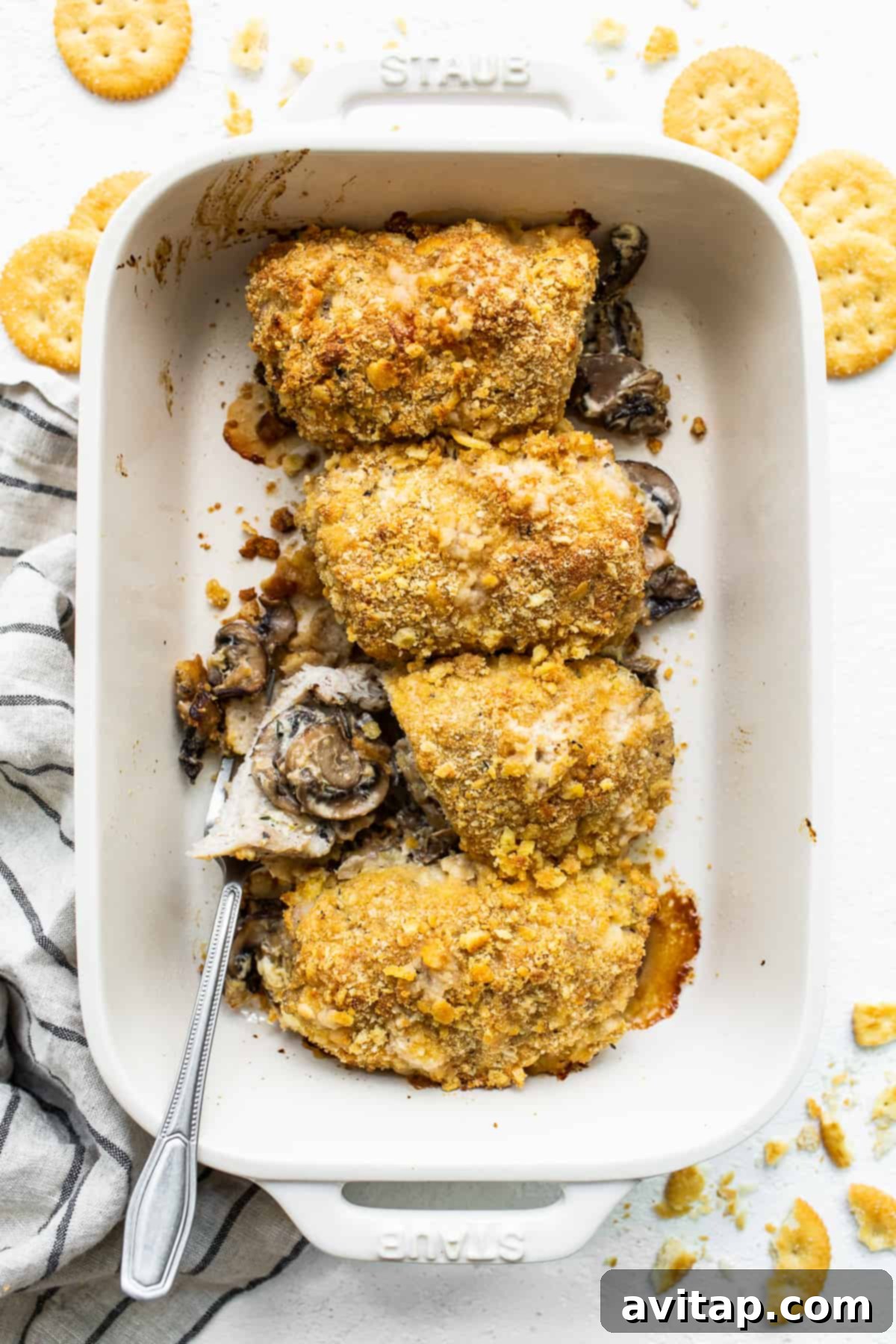 Perfectly Baked Stuffed Pork Chops in Casserole Dish Golden-brown stuffed pork chops resting in a casserole dish after baking.