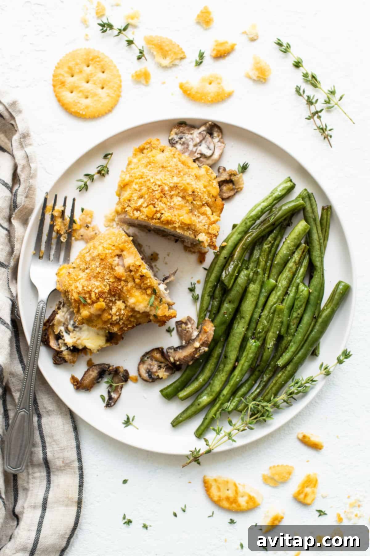 Stuffed Pork Chop Served with Green Beans: A Complete Meal A perfectly cooked stuffed pork chop on a plate with green beans.
