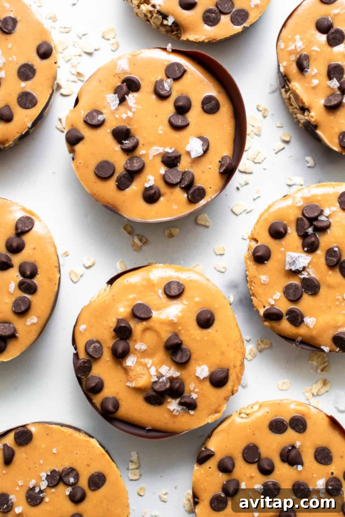 Freshly made peanut butter oat cups cooling on a kitchen counter, ready to be enjoyed as a snack or dessert.