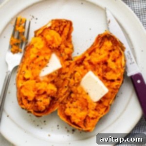 A whole sweet potato resting on a plate, next to a pat of butter, illustrating preparation for microwaving.