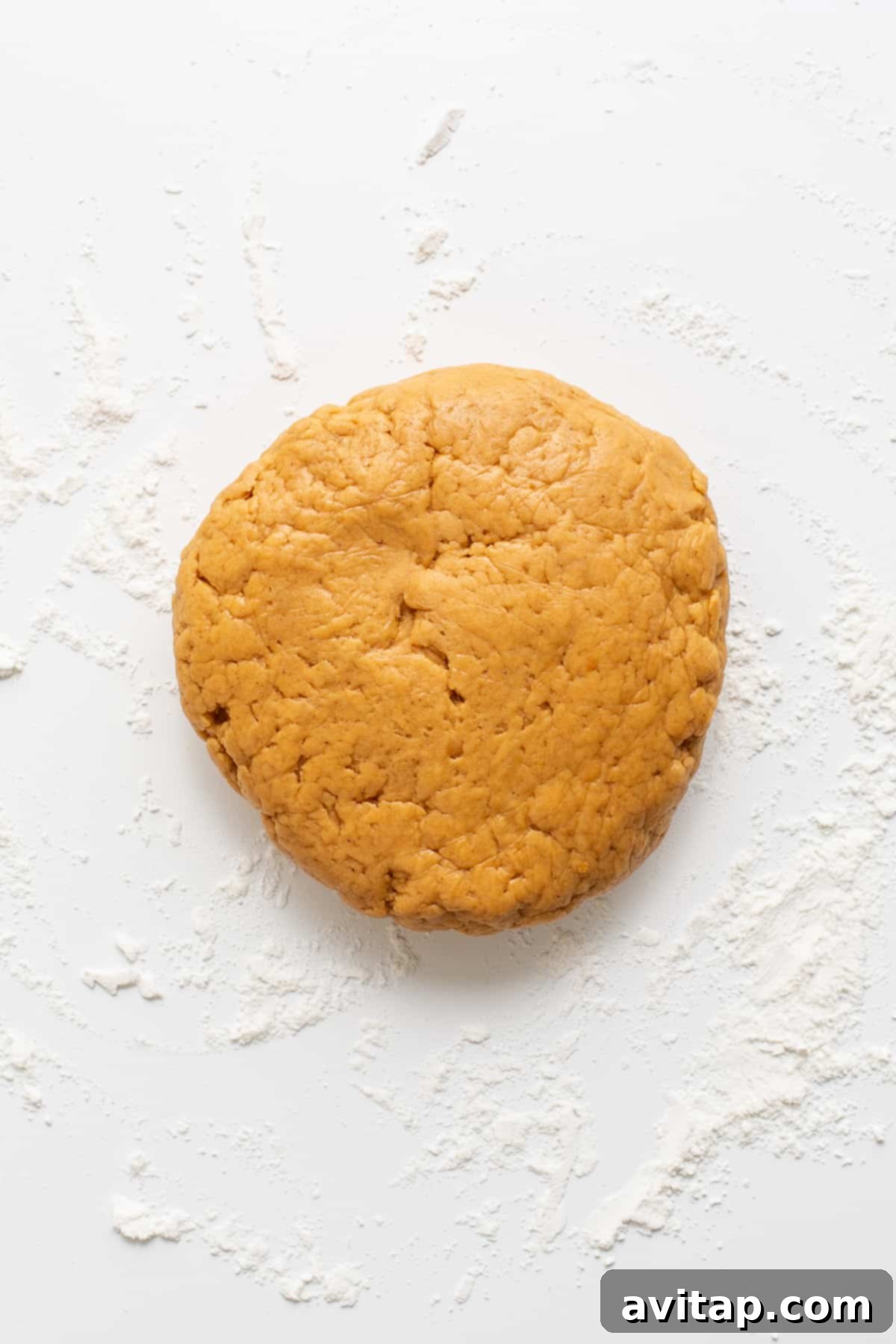 A ball of sticky homemade dog treat dough in a food processor, ready for chilling.