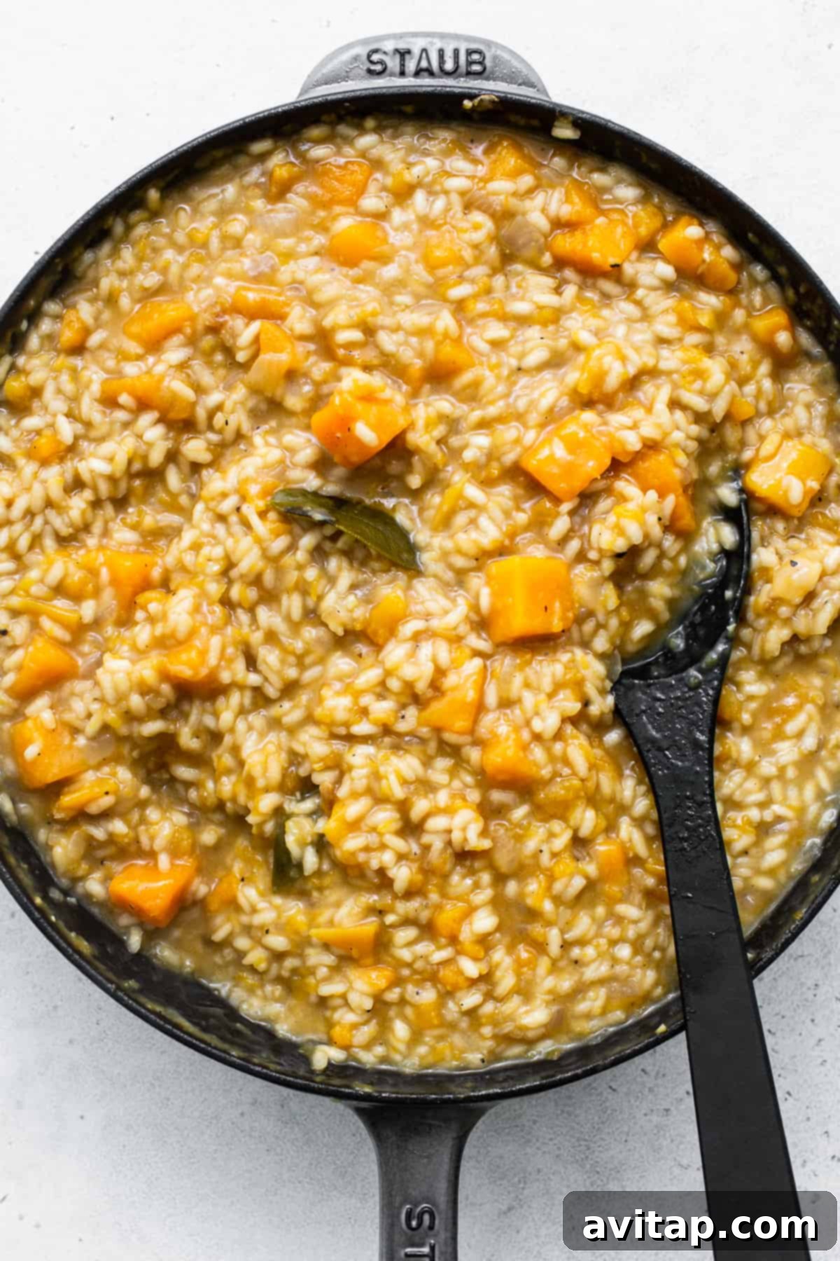 Risotto slowly cooking in a pan, absorbing liquid for a creamy texture.