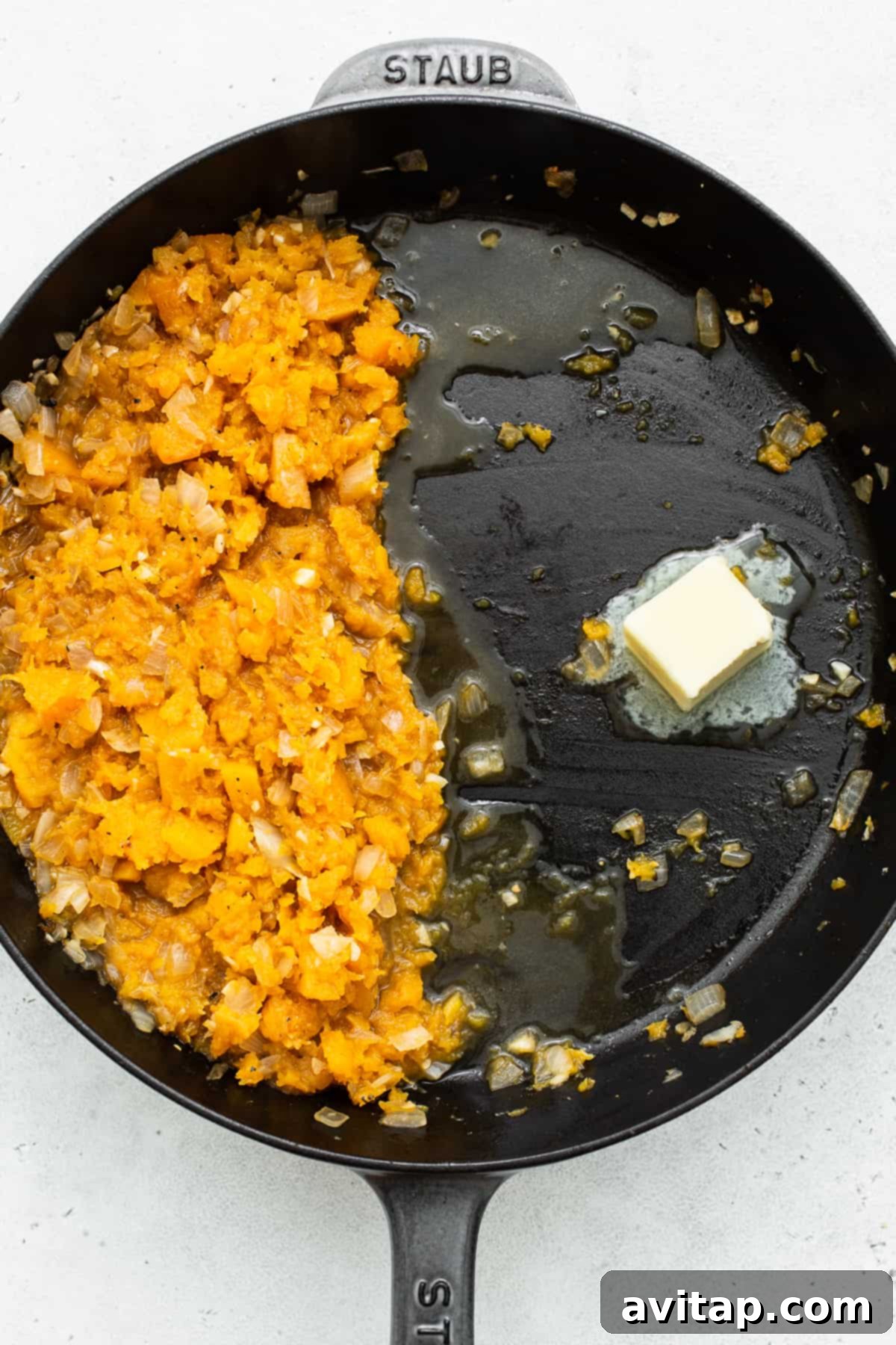 Melting butter in a skillet, preparing to toast the Arborio rice for risotto.