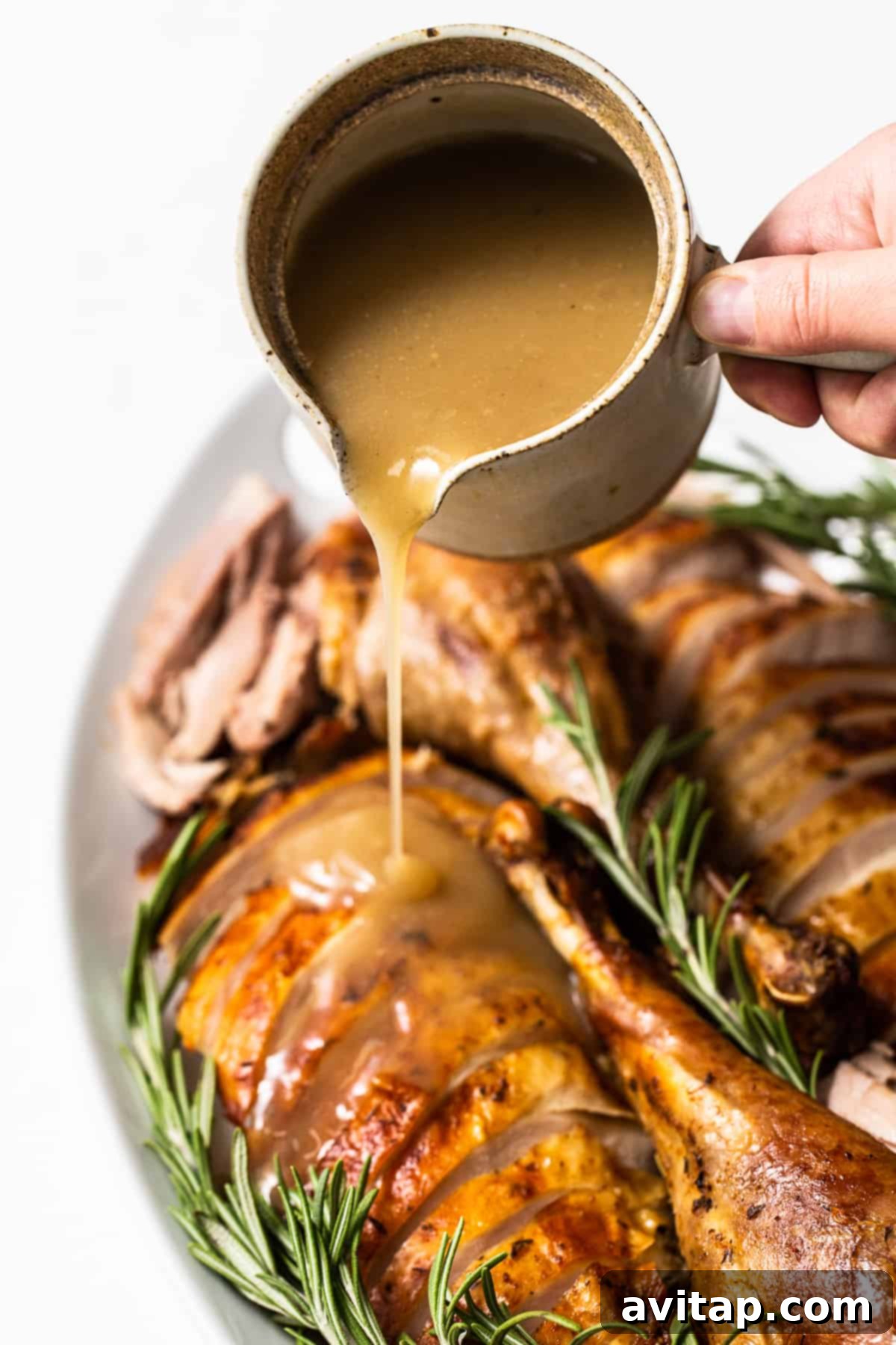 Turkey gravy in a white ceramic gravy boat, ready to be poured.