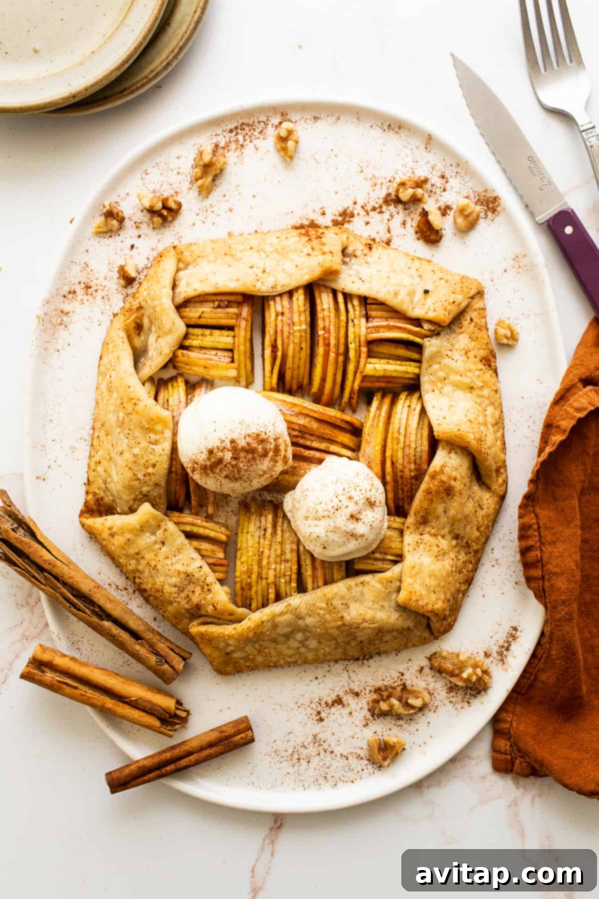 A stunning brown butter apple galette on a cooling rack, showcasing its golden crust and caramelized apples.