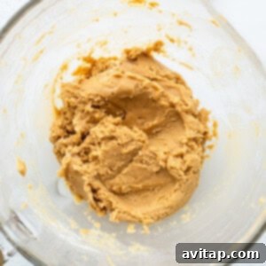 Peanut butter in a glass mixing bowl.